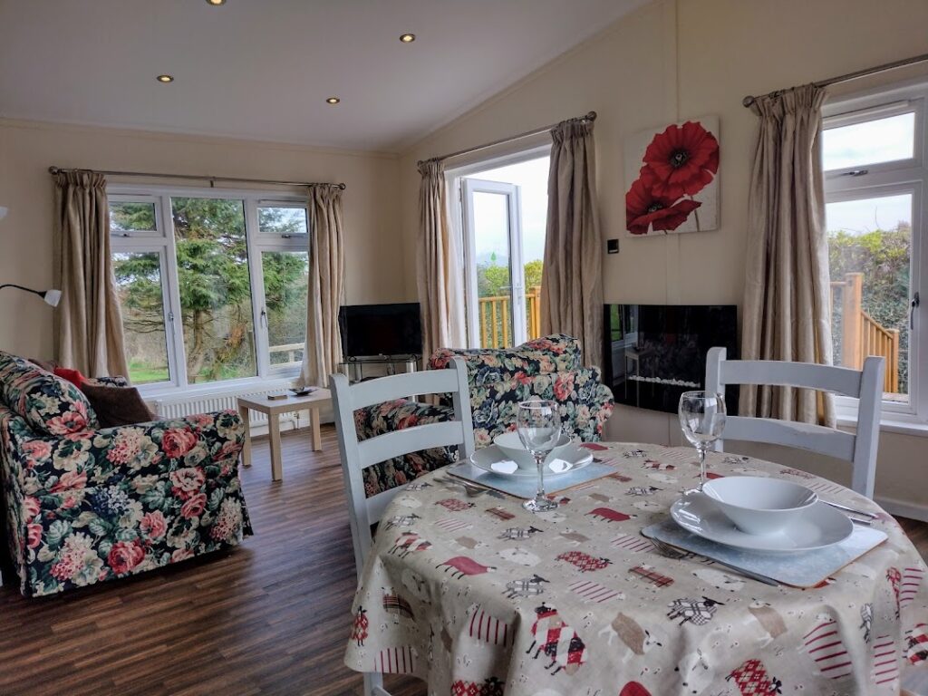 Apple Blossom living and dining room, with floral sofas and a laid table